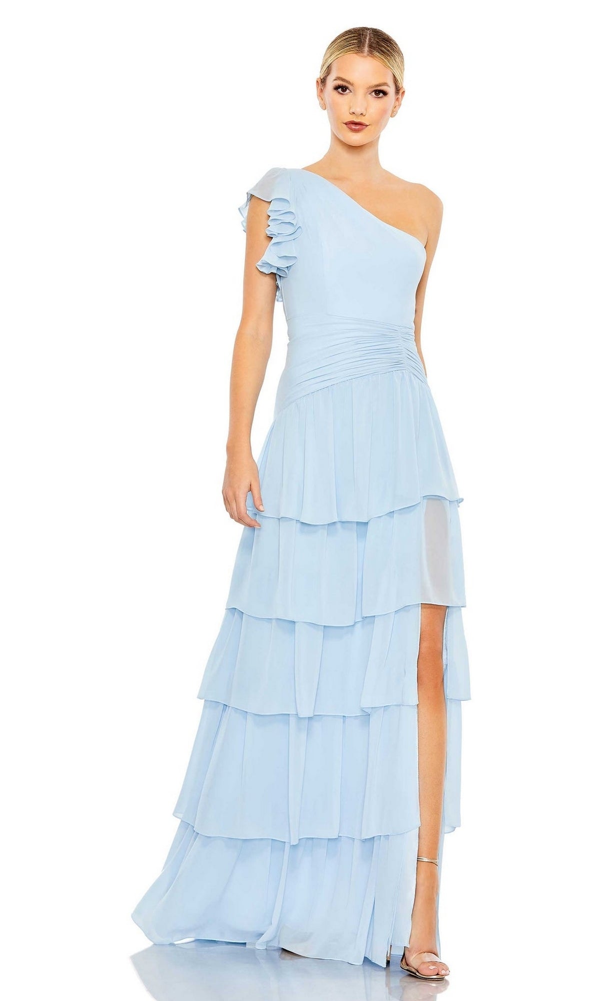 A woman stands facing forward in the Long Formal Dress 55849 by Mac Duggal, a powder blue one-shoulder gown with tiered ruffles and a side slit.